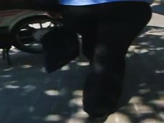A hefty xxxl woman in a street candid video walks in tight black jeans