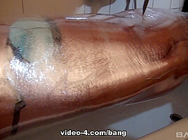 Angel Wicky is fully wrapped in plastic wrap which is filled with water - BANG!