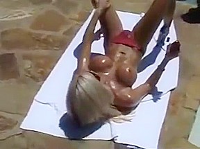 Ashley Lawrence sunbathing by the pool