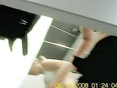 Blonde bimbo trying on to dress in dress room