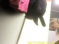 Blonde bimbo trying on to dress in dress room