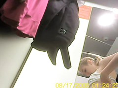 Blonde bimbo trying on to dress in dress room