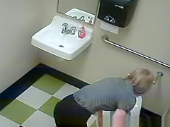Blonde peeing in public toilet