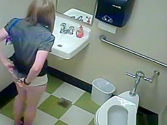 Blonde peeing in public toilet