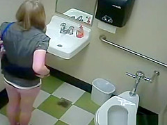 Blonde peeing in public toilet