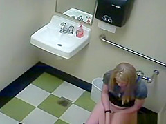 Blonde peeing in public toilet