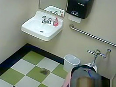 Blonde peeing in public toilet