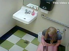 Blonde peeing in public toilet