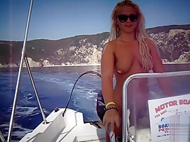 Busty babe naked on a boat