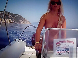 Busty babe naked on a boat