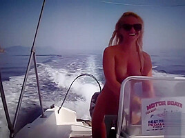 Busty babe naked on a boat