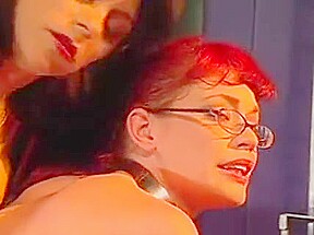 Cute redhead in glasses bound and teased by her mistress