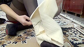 Dancer girl bandages her sprained ankle in black tights