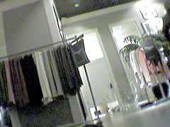 Girl changing in changing room reflecting in the mirror