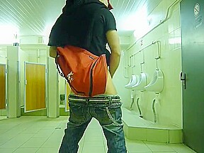 Guy stroke in public toilet