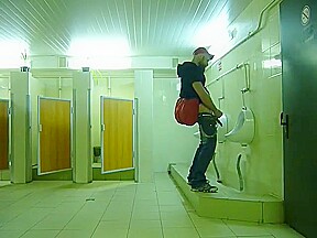 Guy stroke in public toilet