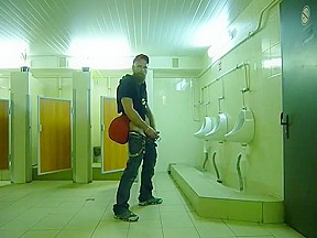 Guy stroke in public toilet