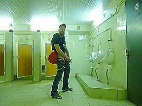 Guy stroke in public toilet