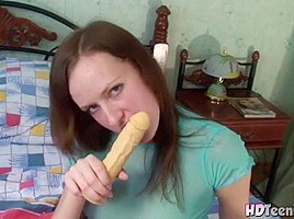 Hot Brunette with natural titrs Sucking Dildo