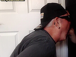 Mature gay closeup sucks and jerks cock through gloryhole