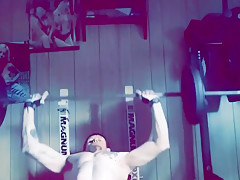 Muscular stud working out nude