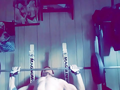 Muscular stud working out nude