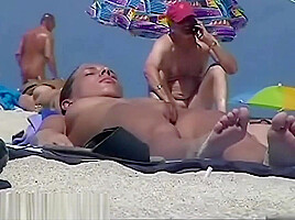 Nude beach with a sexy couple in focus