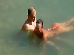 Nudist couple enjoying the fresh water
