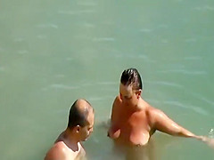 Nudist couple enjoying the fresh water