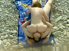 Nudist couple making 69 in the rocky beach