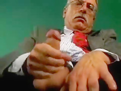 Old man with mustache and glasses masturbates