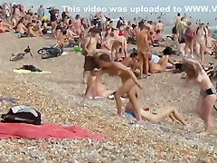 Pretty nudist girl steps out of the water