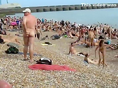 Pretty nudist girl steps out of the water