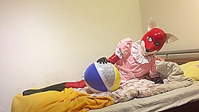 Rubber fox maid plays with beach ball
