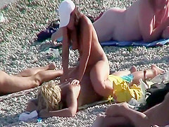 Step daughter massages Step mother on a beach