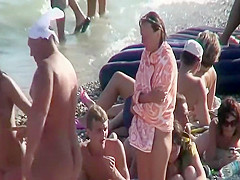 Step daughter massages Step mother on a beach