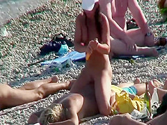 Step daughter massages Step mother on a beach