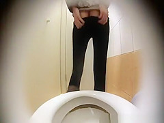 Woman takes a leak in toilet